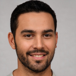 Joyful white young-adult male with short  brown hair and brown eyes