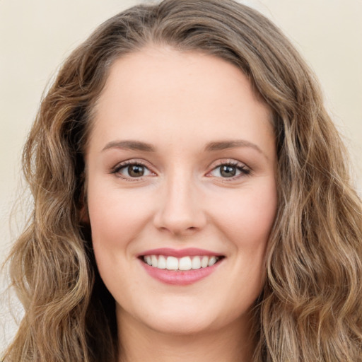 Joyful white young-adult female with long  brown hair and green eyes