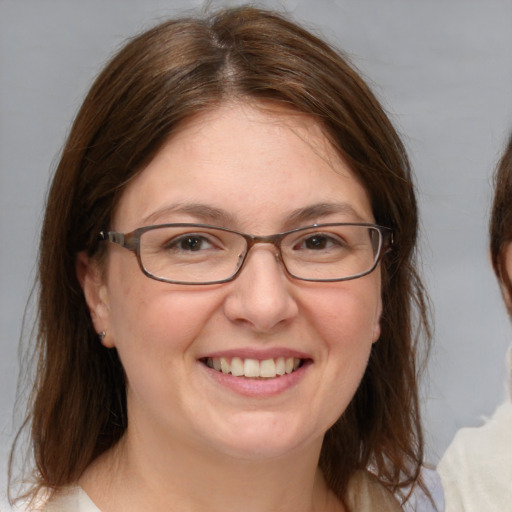 Joyful white adult female with medium  brown hair and brown eyes