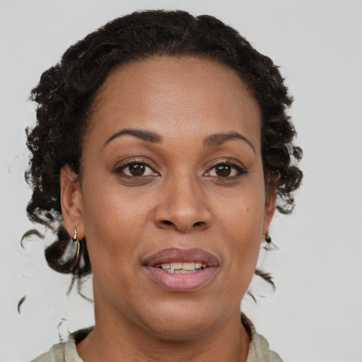 Joyful black adult female with short  brown hair and brown eyes