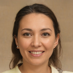 Joyful white young-adult female with medium  brown hair and brown eyes