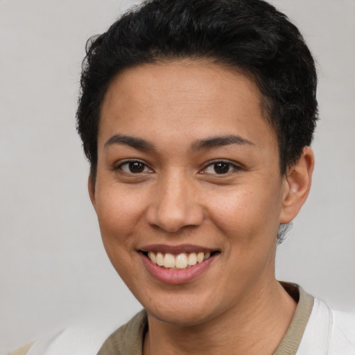 Joyful latino young-adult female with short  brown hair and brown eyes