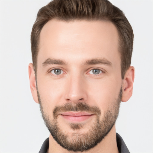 Joyful white young-adult male with short  brown hair and grey eyes