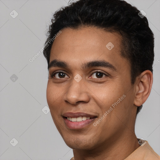 Joyful white young-adult male with short  black hair and brown eyes