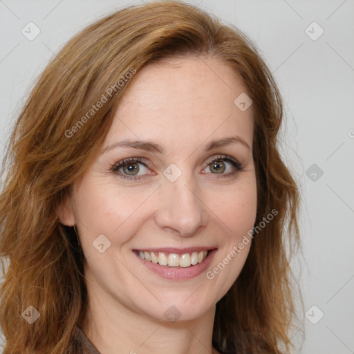 Joyful white adult female with long  brown hair and brown eyes