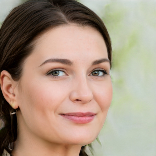 Joyful white young-adult female with long  brown hair and green eyes