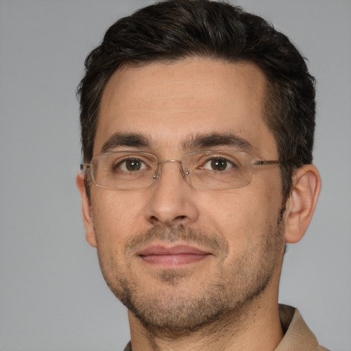 Joyful white adult male with short  brown hair and brown eyes