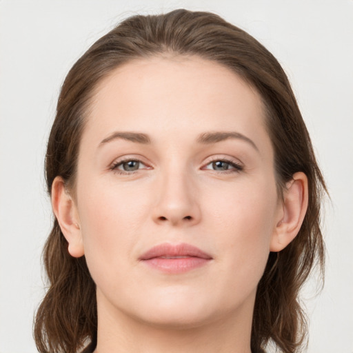 Joyful white young-adult female with long  brown hair and grey eyes