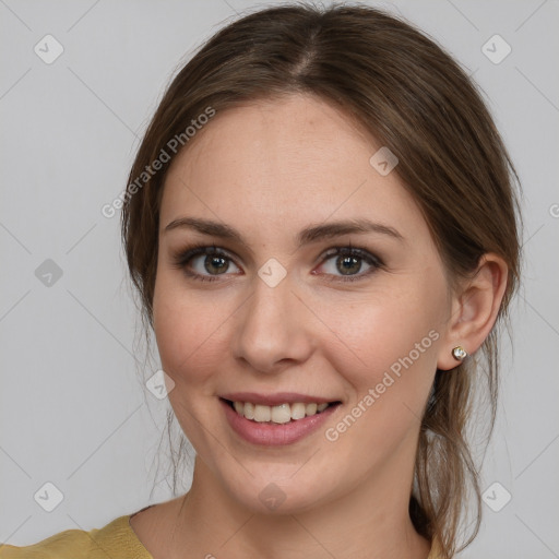 Joyful white young-adult female with medium  brown hair and grey eyes