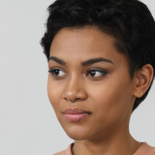 Joyful latino young-adult female with short  black hair and brown eyes