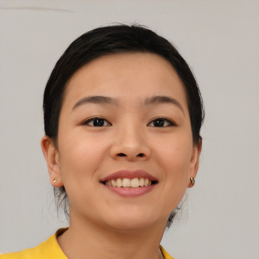 Joyful asian young-adult female with short  brown hair and brown eyes