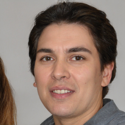 Joyful white adult male with medium  brown hair and brown eyes