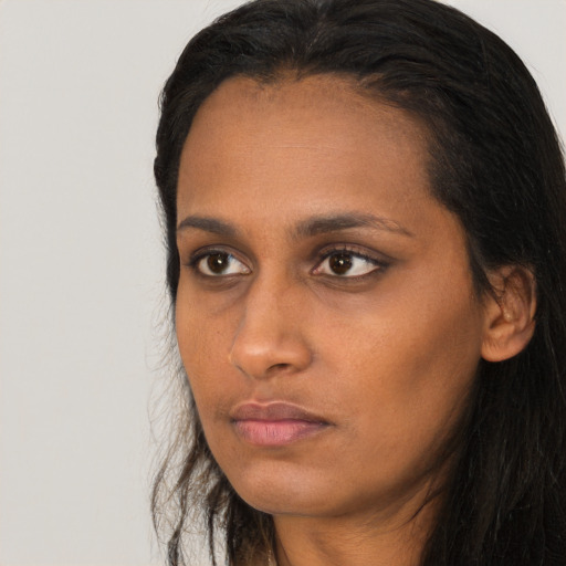 Neutral black young-adult female with long  brown hair and brown eyes