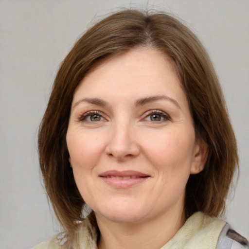 Joyful white adult female with medium  brown hair and grey eyes