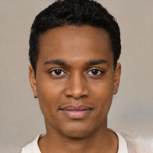 Joyful black young-adult male with short  black hair and brown eyes