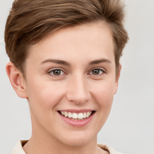 Joyful white young-adult female with short  brown hair and grey eyes