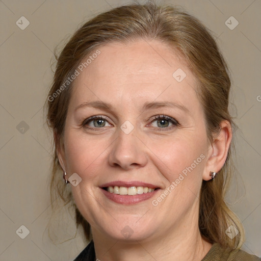 Joyful white adult female with medium  brown hair and blue eyes