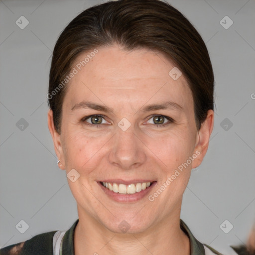 Joyful white adult female with short  brown hair and grey eyes