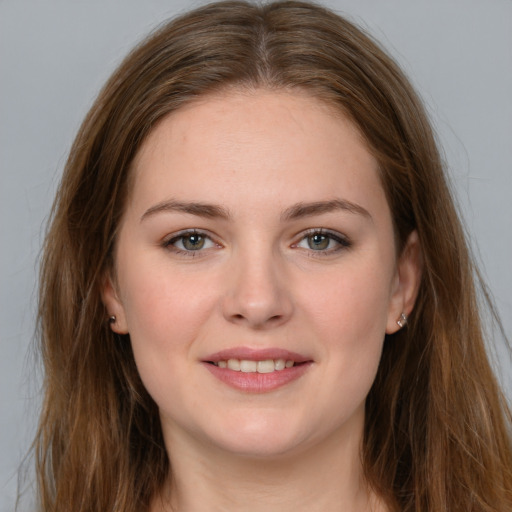 Joyful white young-adult female with long  brown hair and grey eyes