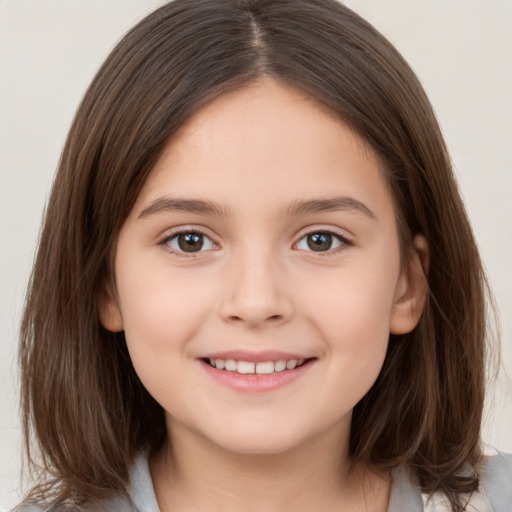 Joyful white child female with medium  brown hair and brown eyes