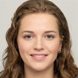 Joyful white young-adult female with long  brown hair and green eyes