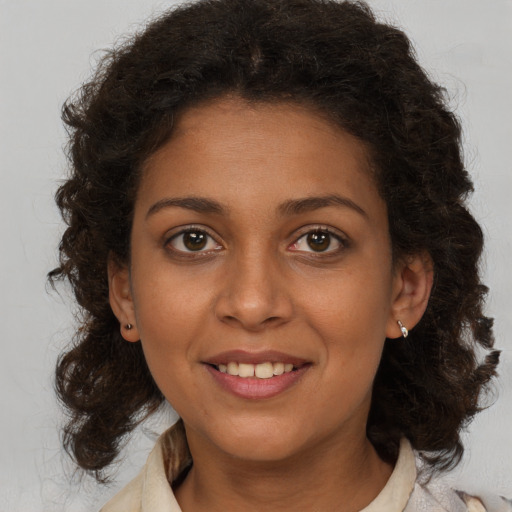 Joyful black young-adult female with medium  brown hair and brown eyes