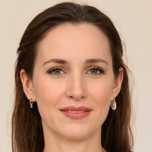 Joyful white young-adult female with long  brown hair and grey eyes