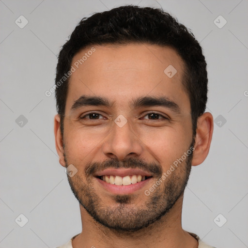 Joyful white young-adult male with short  black hair and brown eyes