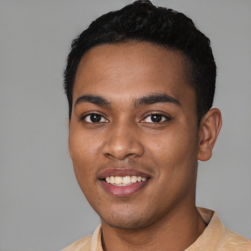 Joyful black young-adult male with short  black hair and brown eyes