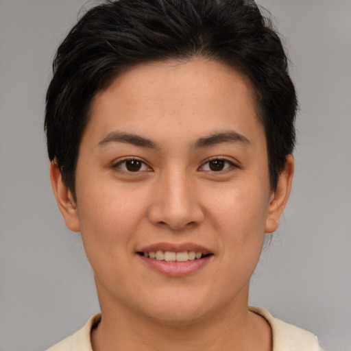 Joyful asian young-adult female with short  brown hair and brown eyes