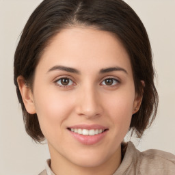 Joyful white young-adult female with medium  brown hair and brown eyes