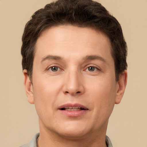 Joyful white adult male with short  brown hair and brown eyes