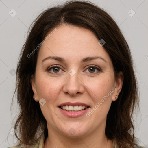 Joyful white adult female with medium  brown hair and green eyes