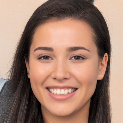 Joyful white young-adult female with long  brown hair and brown eyes