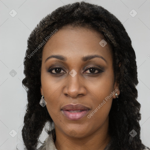 Joyful black young-adult female with long  black hair and brown eyes