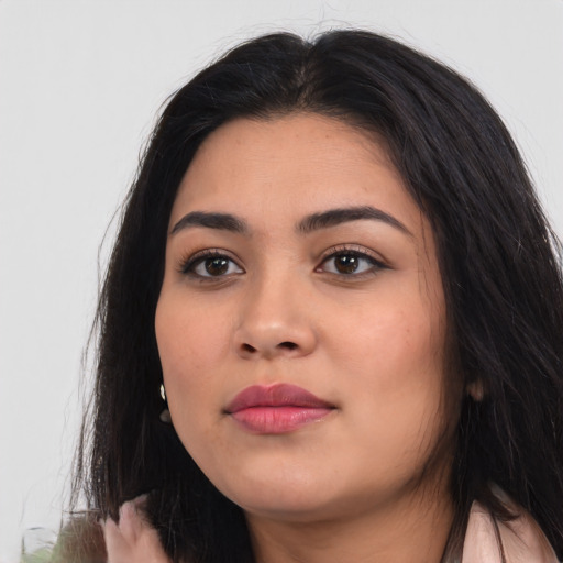 Joyful latino young-adult female with long  black hair and brown eyes