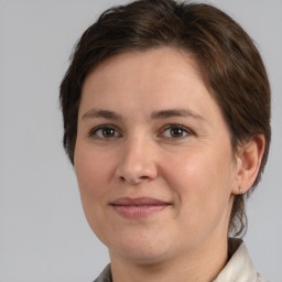 Joyful white adult female with medium  brown hair and brown eyes