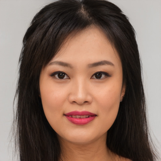 Joyful asian young-adult female with long  brown hair and brown eyes