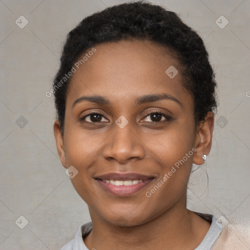 Joyful black young-adult female with short  brown hair and brown eyes