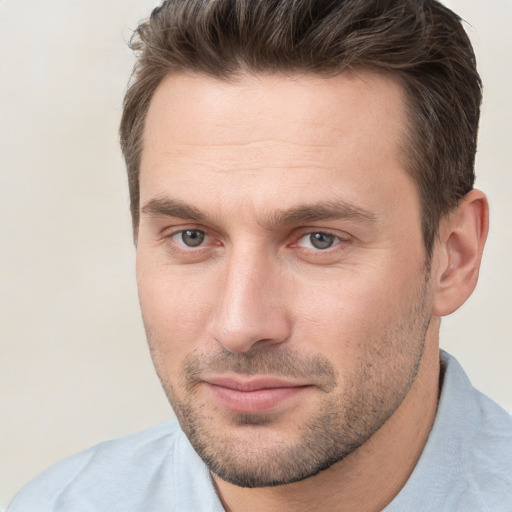 Joyful white young-adult male with short  brown hair and brown eyes