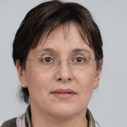 Joyful white adult female with medium  brown hair and grey eyes