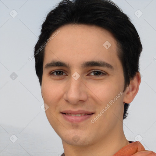 Joyful white young-adult male with short  black hair and brown eyes