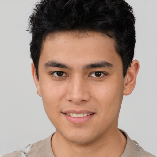 Joyful asian young-adult male with short  brown hair and brown eyes