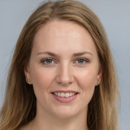 Joyful white young-adult female with long  brown hair and grey eyes