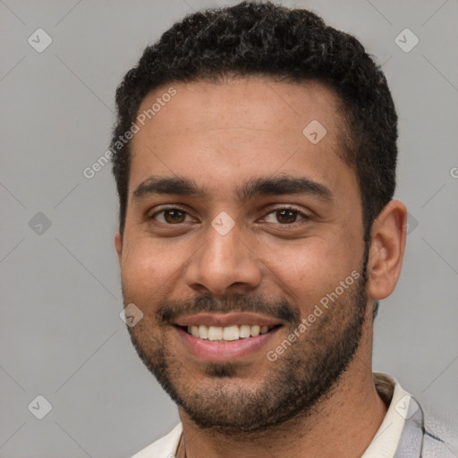 Joyful white young-adult male with short  black hair and brown eyes