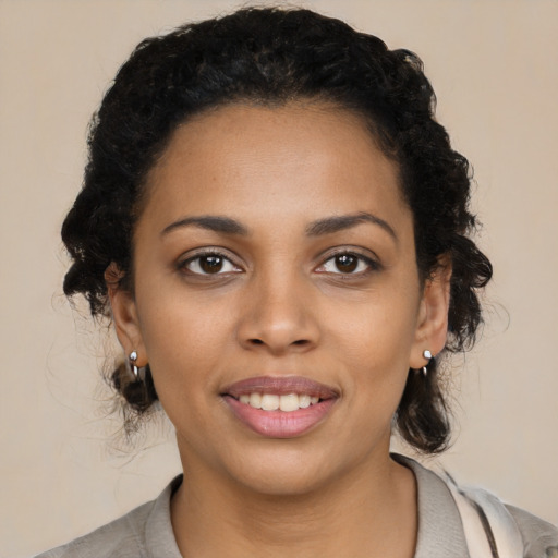 Joyful black young-adult female with medium  black hair and brown eyes