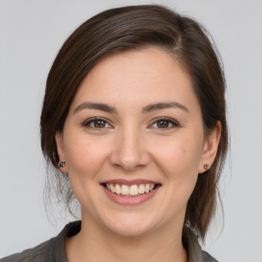 Joyful white young-adult female with medium  brown hair and brown eyes