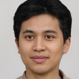 Joyful asian young-adult male with short  black hair and brown eyes