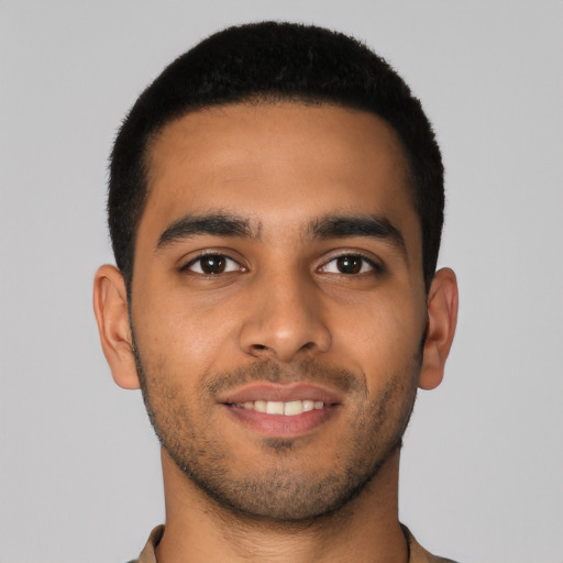 Joyful latino young-adult male with short  brown hair and brown eyes