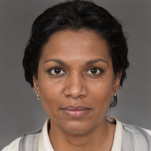 Joyful black adult female with short  brown hair and brown eyes